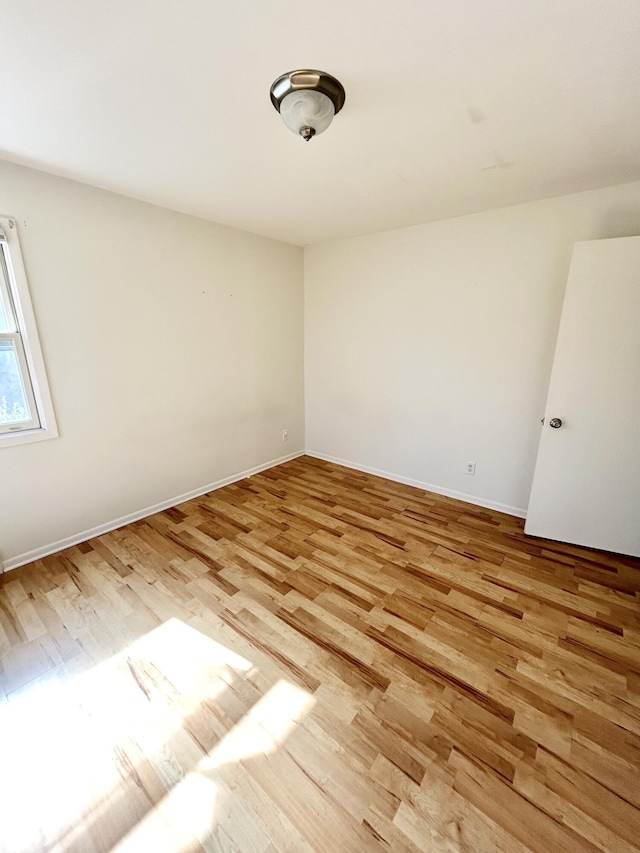 unfurnished room featuring light wood finished floors and baseboards