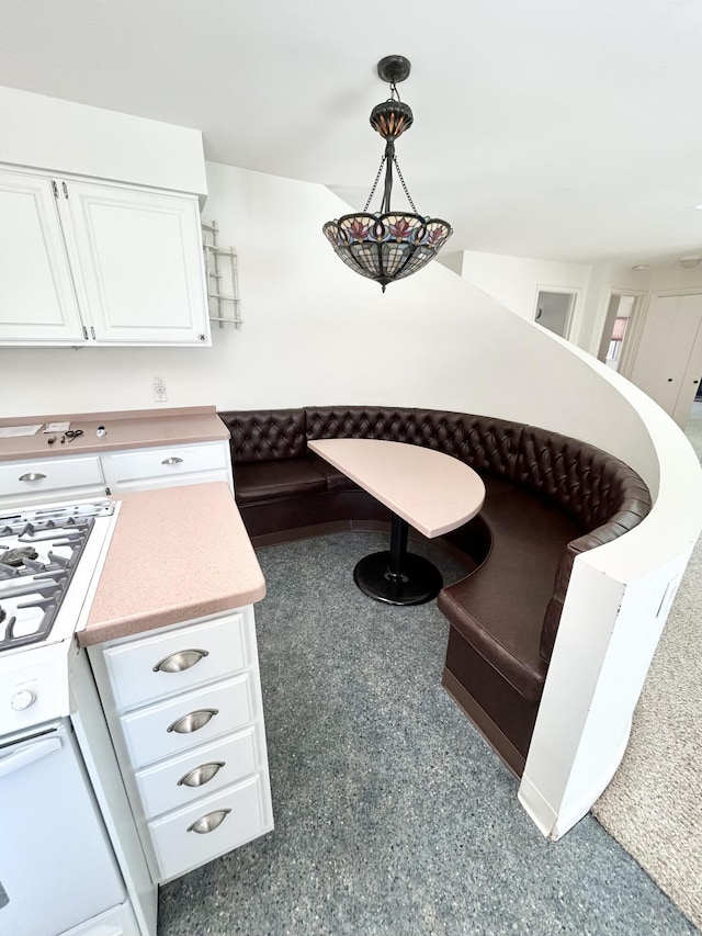 details featuring hanging light fixtures, white cabinetry, and light countertops