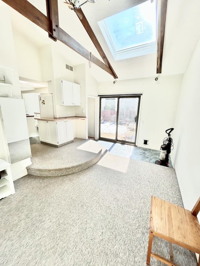 carpeted living area with high vaulted ceiling, beam ceiling, a skylight, and visible vents