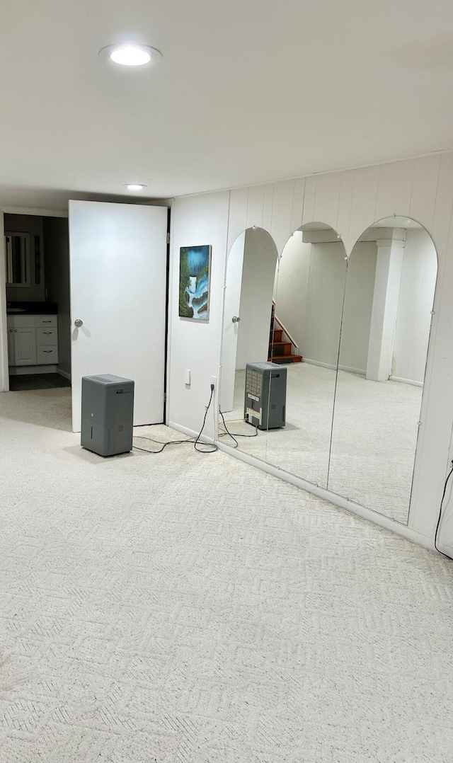 unfurnished bedroom with arched walkways, carpet, and recessed lighting