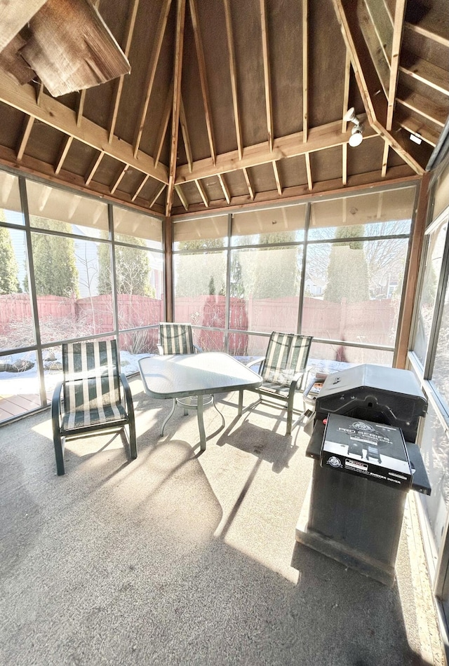 sunroom featuring lofted ceiling