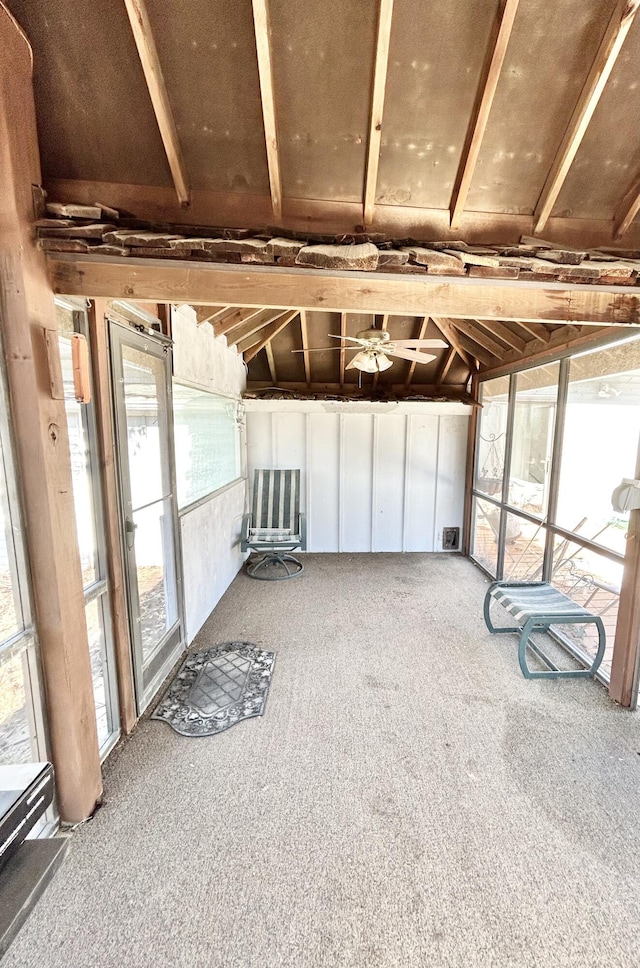 unfurnished sunroom featuring vaulted ceiling