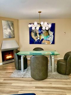 dining room with breakfast area, baseboards, a notable chandelier, and wood finished floors