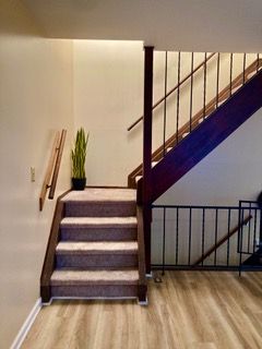 stairs with baseboards and wood finished floors