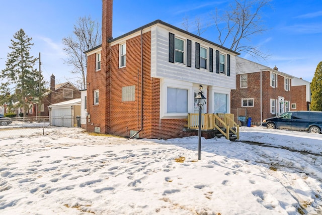 view of front of house featuring a garage, brick siding, and a chimney