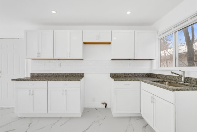 kitchen with recessed lighting, a sink, white cabinetry, marble finish floor, and decorative backsplash