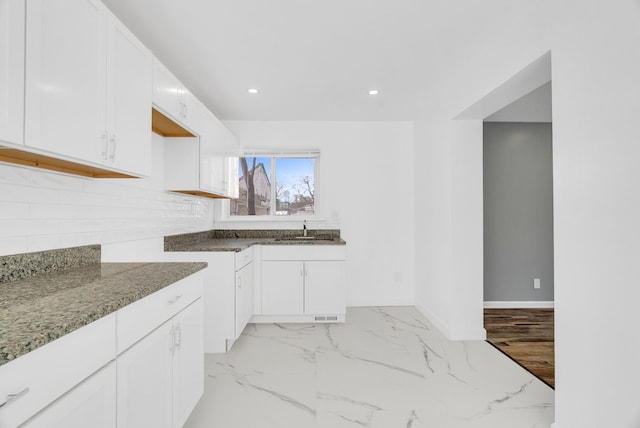 kitchen with marble finish floor, recessed lighting, stone countertops, and white cabinets