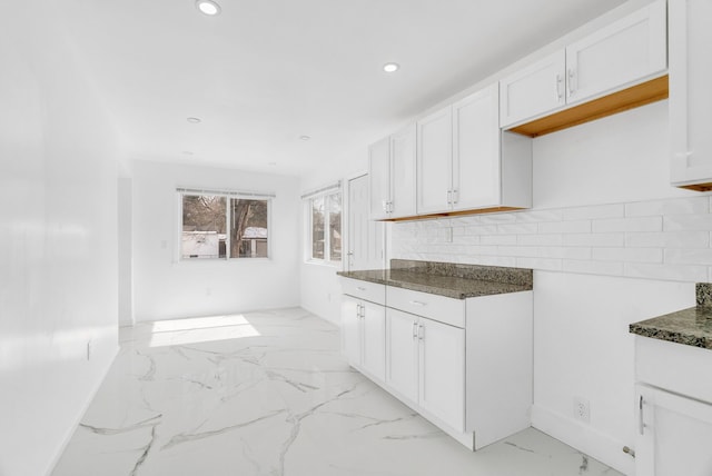 kitchen with recessed lighting, marble finish floor, white cabinets, and dark stone countertops