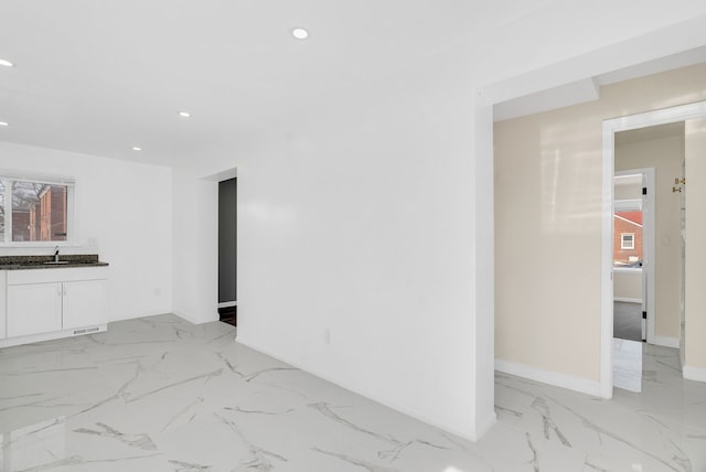 empty room with recessed lighting, a sink, visible vents, baseboards, and marble finish floor