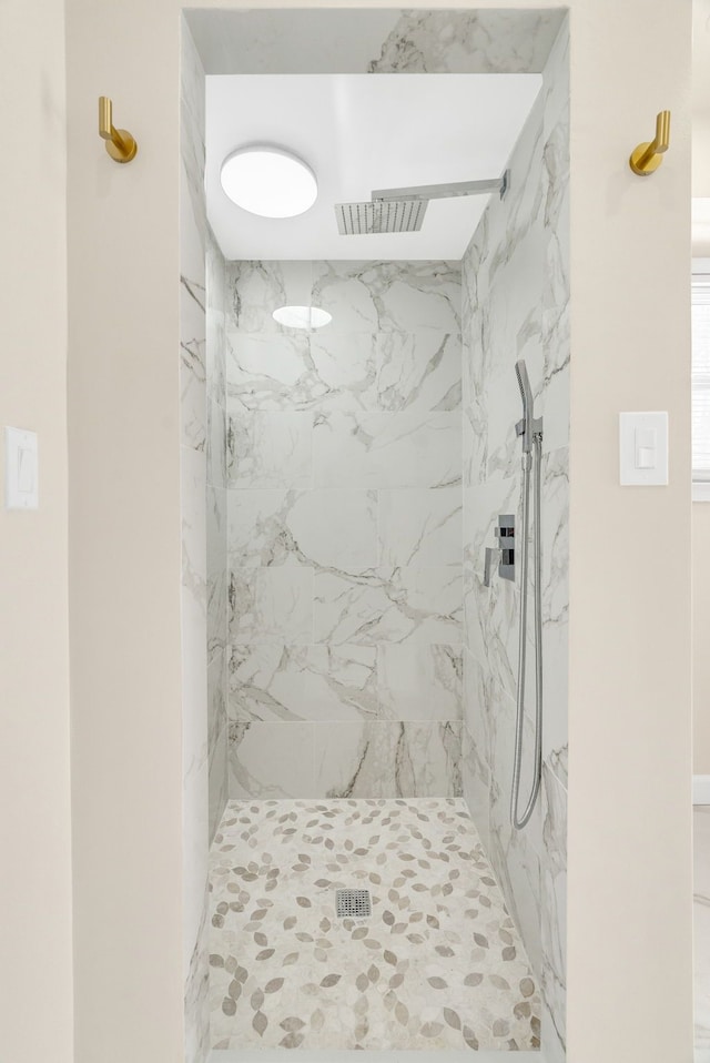 bathroom featuring a marble finish shower and visible vents