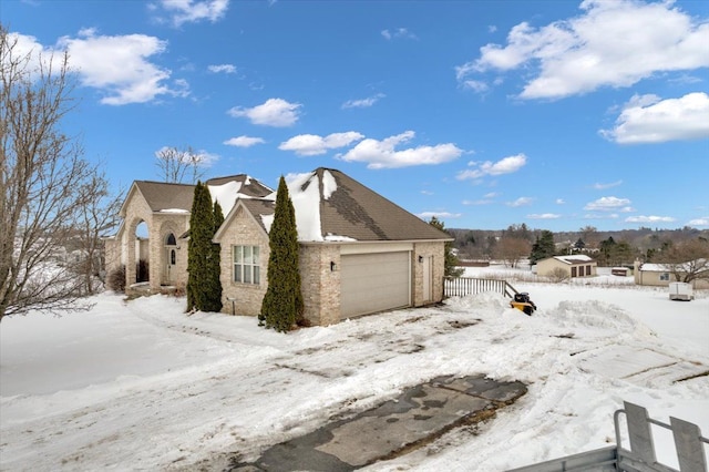 3912 Alex Ct, Oxford, MI 48371 - view of snowy exterior featuring brick siding and an attached garage