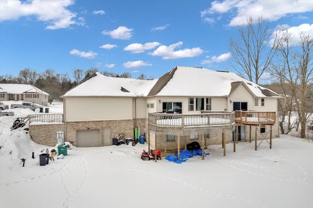 3912 Alex Ct, Oxford, MI 48371 - snow covered property with a deck, an attached garage, and brick siding