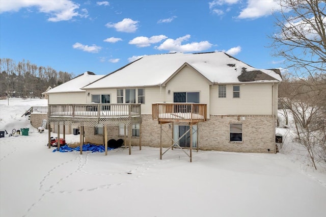 3912 Alex Ct, Oxford, MI 48371 - snow covered house featuring brick siding and a wooden deck