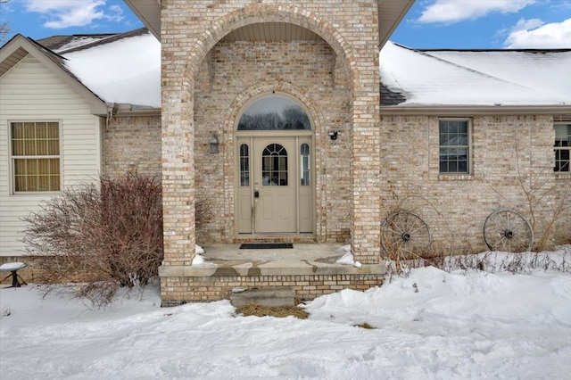 3912 Alex Ct, Oxford, MI 48371 - snow covered property entrance featuring brick siding