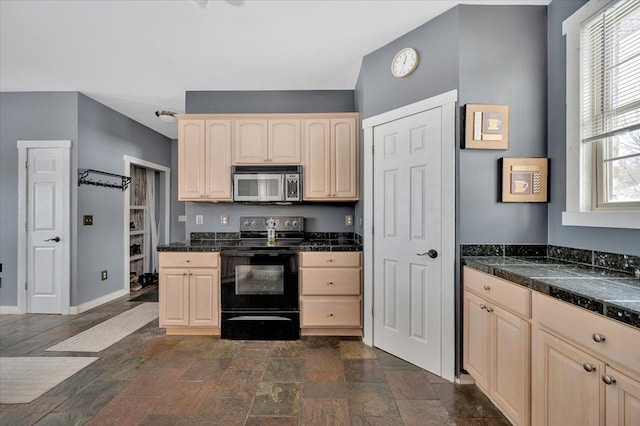 3912 Alex Ct, Oxford, MI 48371 - kitchen featuring black electric range oven, stainless steel microwave, light brown cabinetry, baseboards, and tile countertops