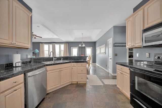 3912 Alex Ct, Oxford, MI 48371 - kitchen featuring stainless steel appliances, light brown cabinets, a sink, a peninsula, and a raised ceiling