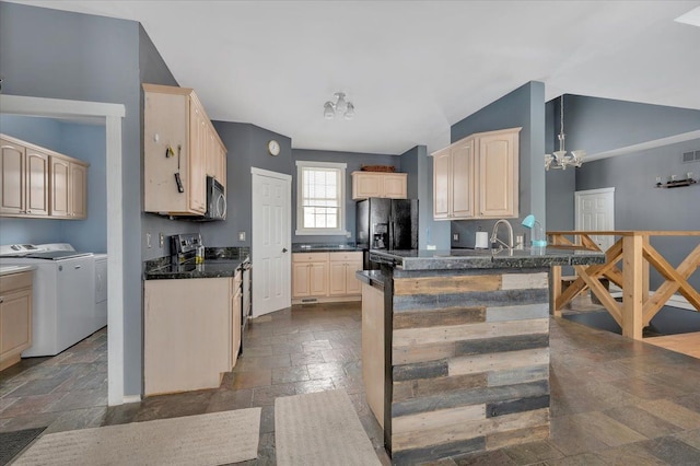 3912 Alex Ct, Oxford, MI 48371 - kitchen featuring separate washer and dryer, stainless steel appliances, stone tile floors, a peninsula, and a chandelier