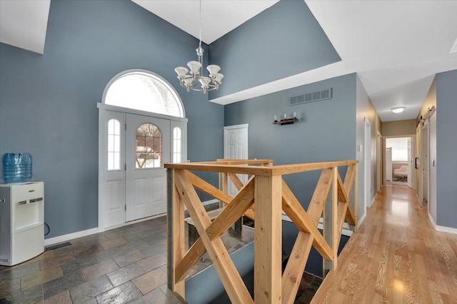 3912 Alex Ct, Oxford, MI 48371 - foyer with a chandelier, a high ceiling, and baseboards