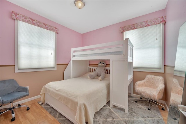 3912 Alex Ct, Oxford, MI 48371 - bedroom with multiple windows, wood finished floors, and baseboards