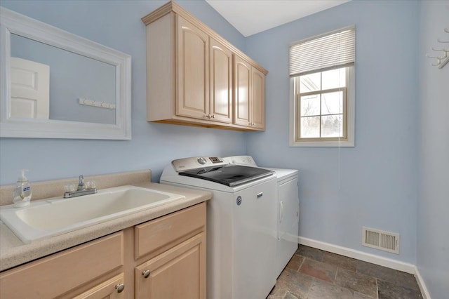 3912 Alex Ct, Oxford, MI 48371 - laundry area featuring washer and dryer, cabinet space, baseboards, and dark stone finish floors