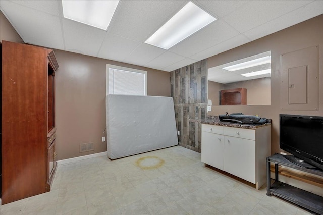 3912 Alex Ct, Oxford, MI 48371 - kitchen with a drop ceiling, white cabinets, baseboards, and electric panel