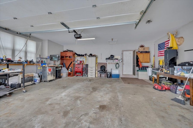 3912 Alex Ct, Oxford, MI 48371 - garage featuring a garage door opener and a workshop area