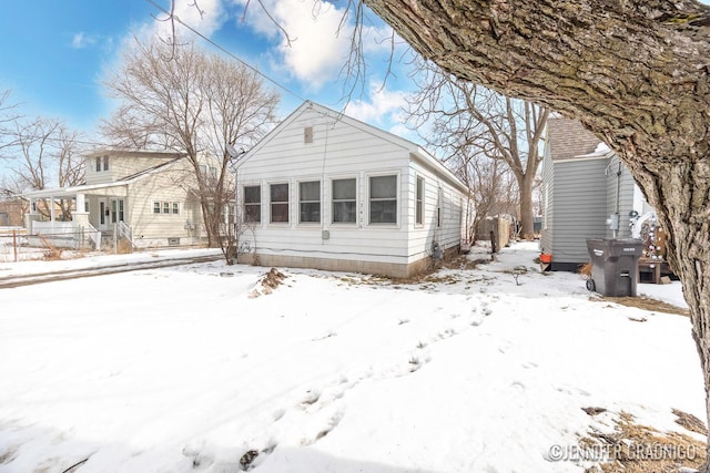 view of snow covered rear of property