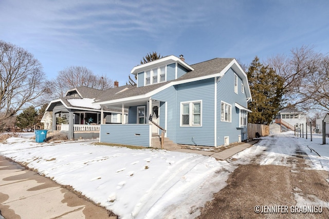 bungalow-style home with a porch, a shingled roof, and a chimney