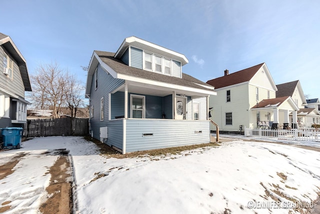 bungalow-style home with covered porch and fence