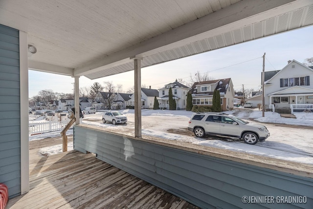 wooden deck featuring covered porch and a residential view