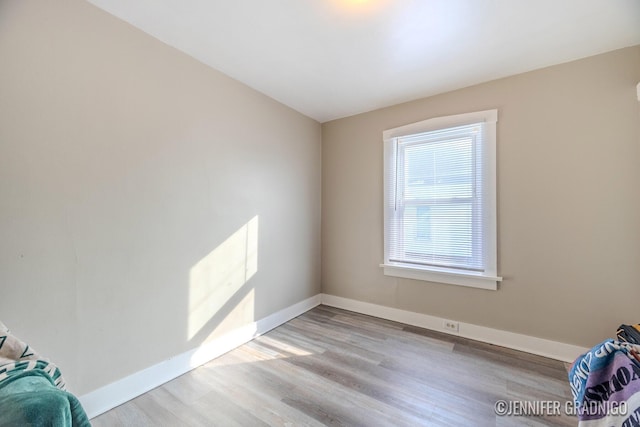 empty room featuring light wood-style floors and baseboards