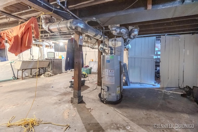 unfinished basement with gas water heater and a sink