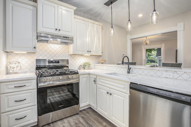 kitchen featuring under cabinet range hood, a sink, white cabinetry, appliances with stainless steel finishes, and light wood finished floors