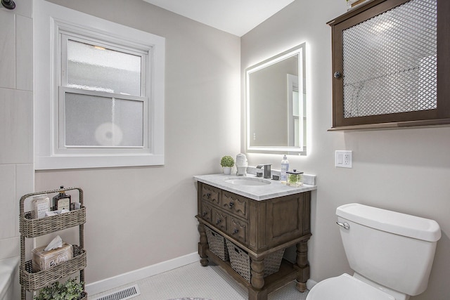 bathroom featuring baseboards, visible vents, vanity, and toilet