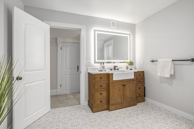 bathroom featuring vanity, visible vents, and baseboards