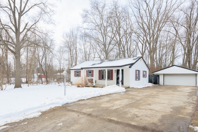 view of front of property with a garage and an outbuilding