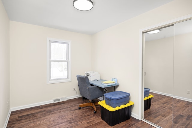 office space with visible vents, baseboards, and wood finished floors