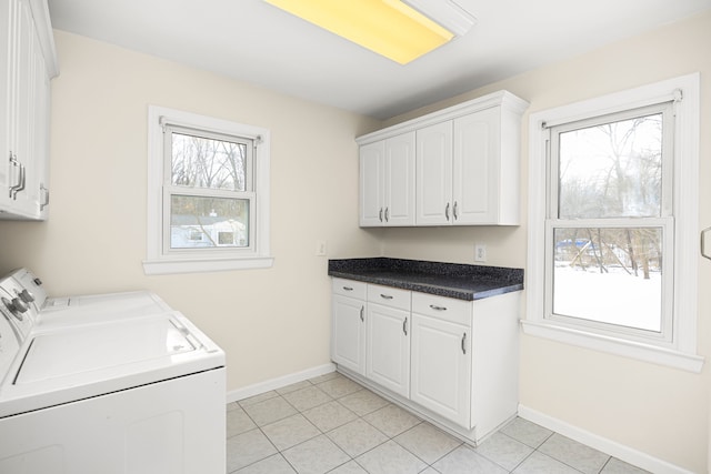 laundry area with washer and dryer, cabinet space, baseboards, and light tile patterned flooring