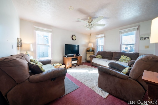 living area with a textured ceiling, ceiling fan, and carpet flooring