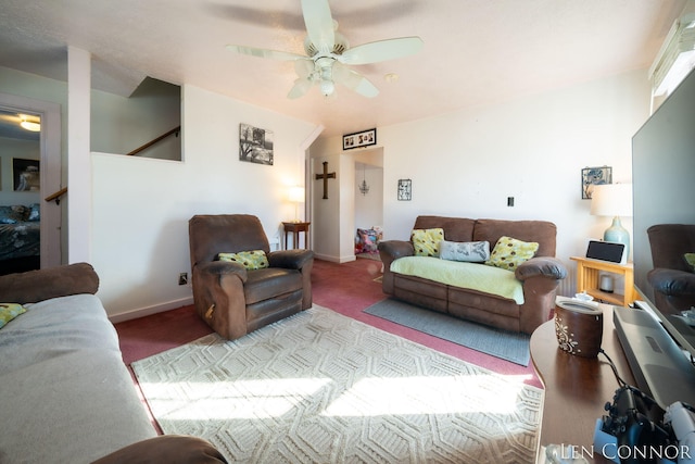 living room with baseboards, a ceiling fan, and light colored carpet