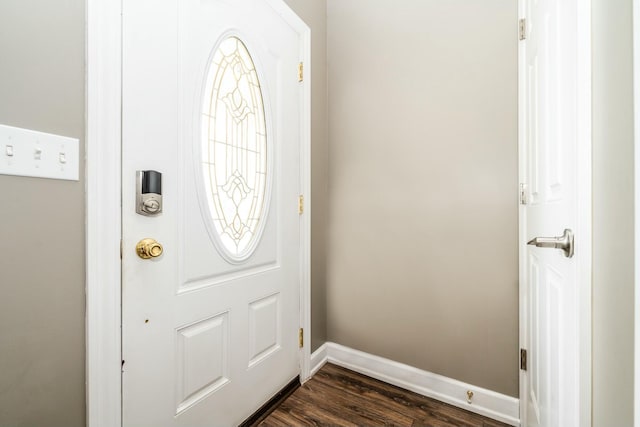 foyer entrance featuring dark wood-style floors and baseboards