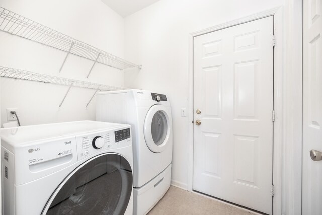 washroom featuring laundry area and separate washer and dryer