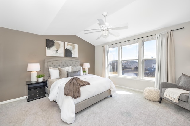 bedroom featuring light carpet, ceiling fan, baseboards, and lofted ceiling