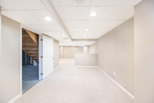 finished below grade area with light carpet, baseboards, and recessed lighting