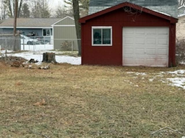 exterior space with a garage and an outbuilding