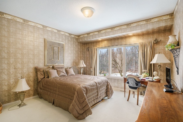 carpeted bedroom featuring wallpapered walls and baseboards