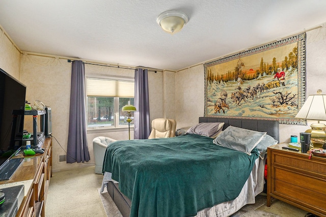 bedroom featuring carpet and a textured ceiling