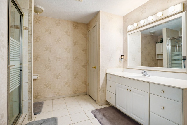 bathroom with vanity, baseboards, tile patterned floors, a stall shower, and wallpapered walls