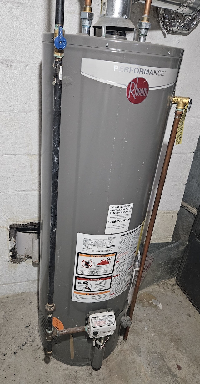 utility room featuring gas water heater