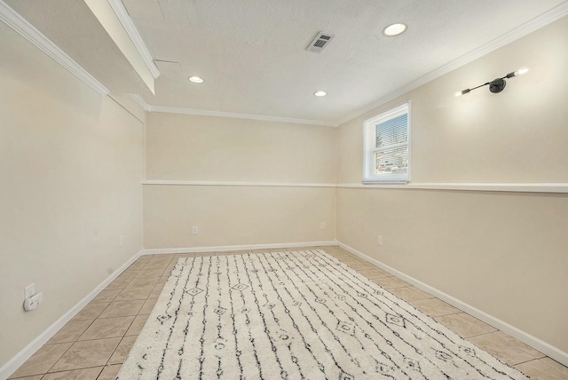 below grade area featuring baseboards, visible vents, light tile patterned flooring, crown molding, and recessed lighting